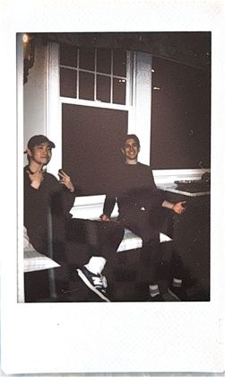 Two teammates lounging on a window seat at night