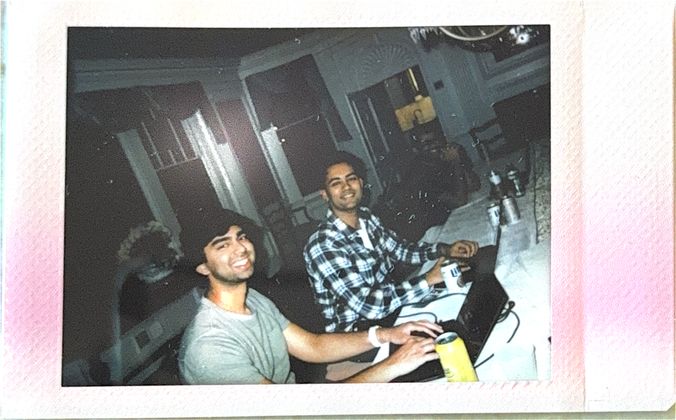 Two teammates at their laptops, mid-hack