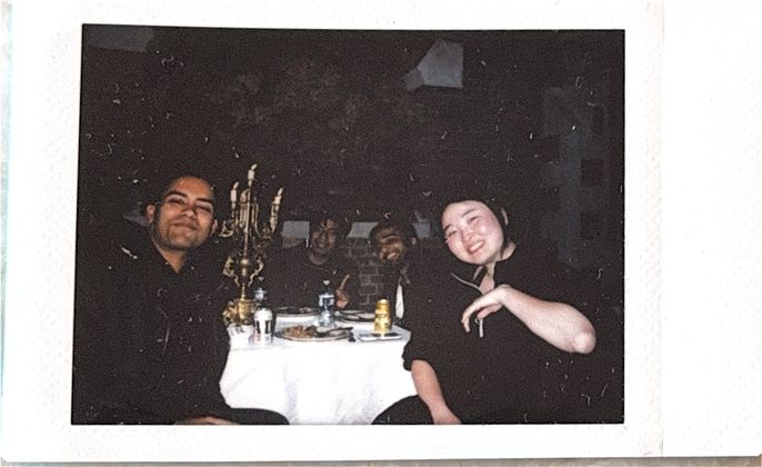 A group selfie around a candlelit table